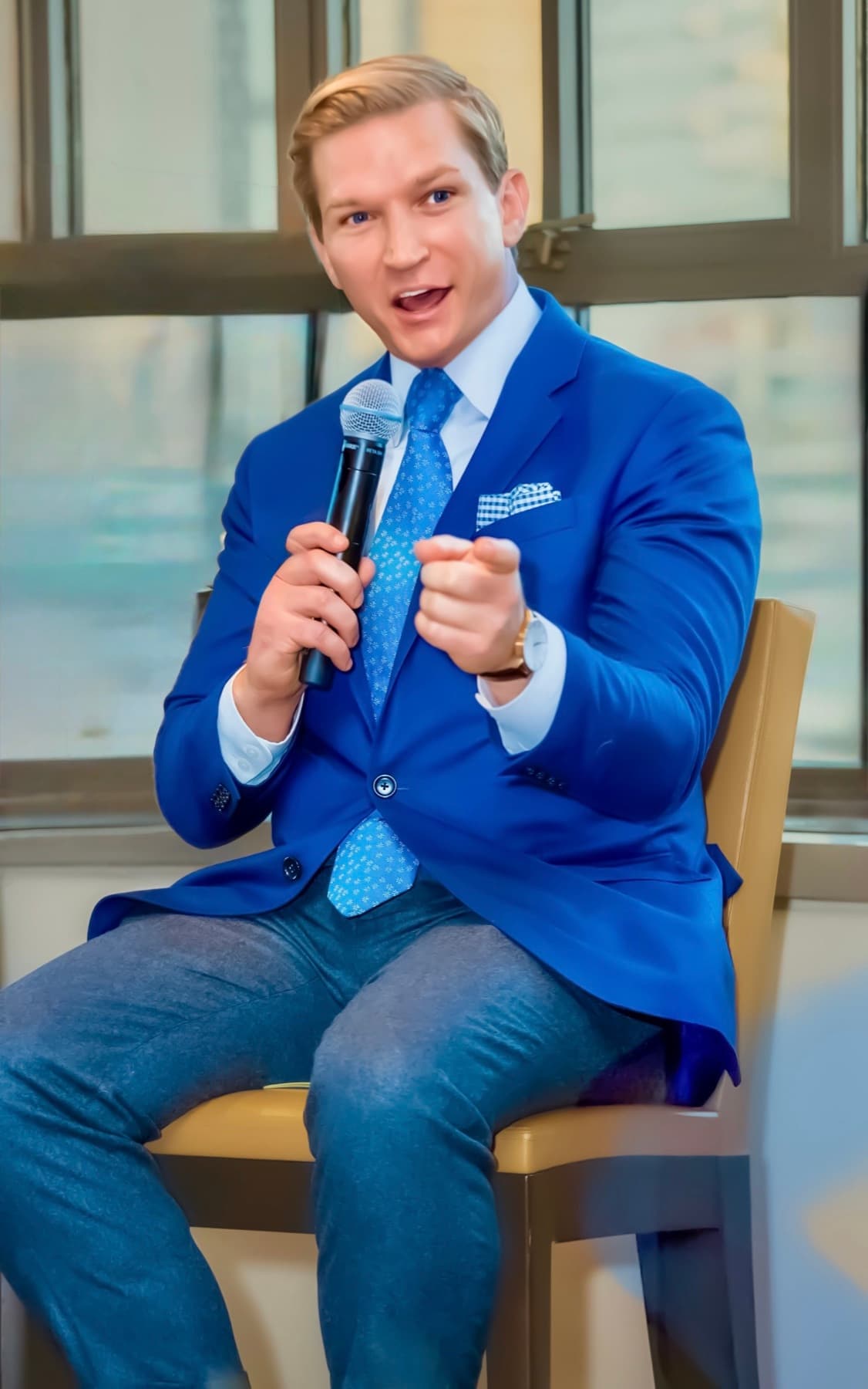 Brendan Hart speaking with a handheld microphone.